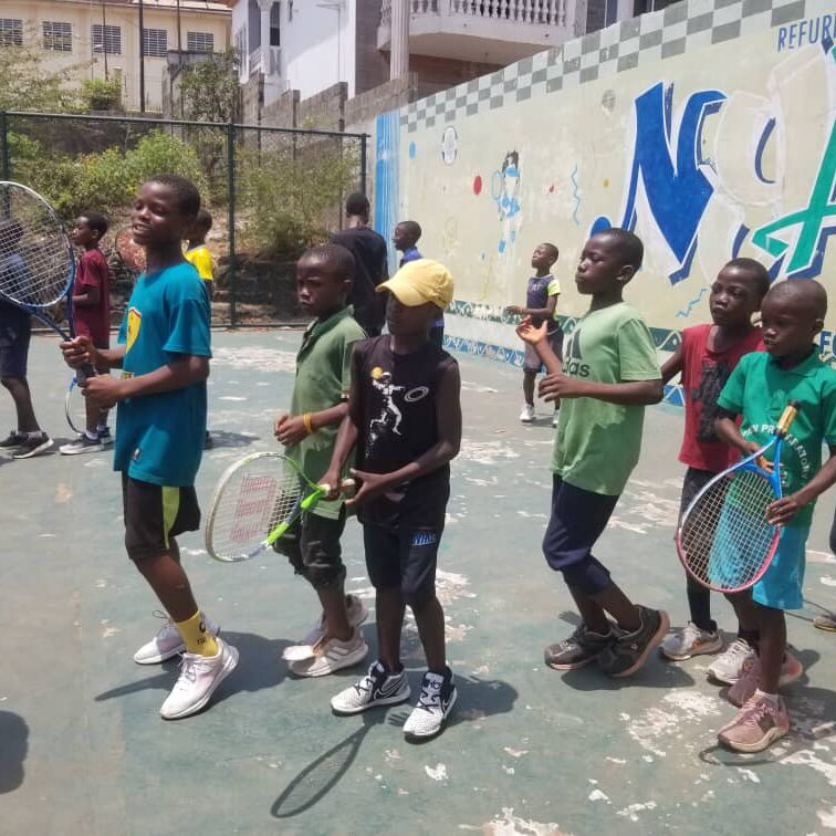 Students lining up for a tennis lesson