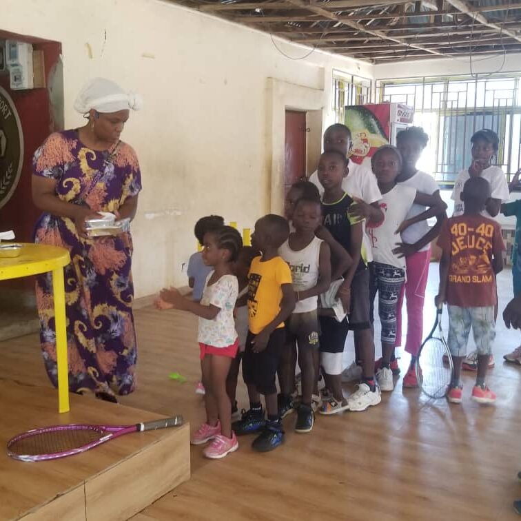 Children lining up for a meal after practice